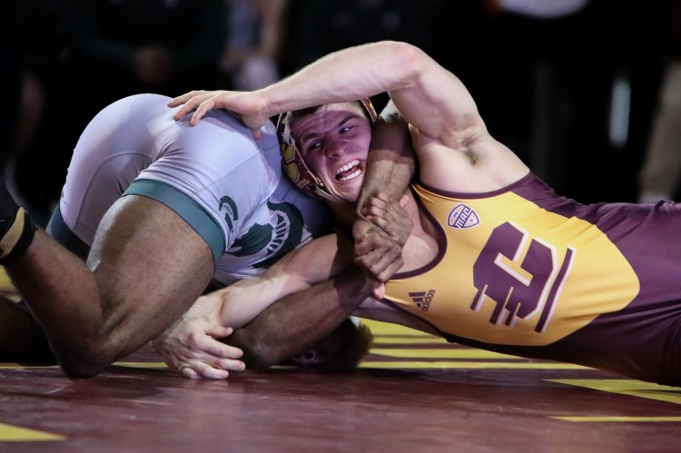 Flushing redshirt freshman Ben Cushman locked in a hold against his MSU opponent.