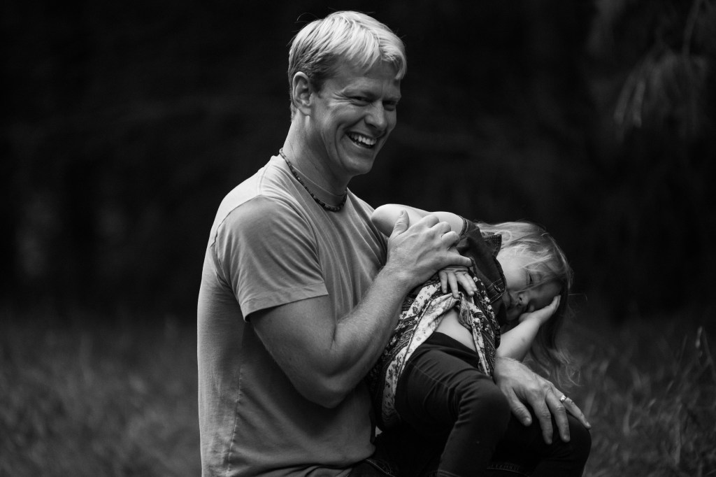 Jason Byrne and his daughter pose for family portraits near Winn, MI.
